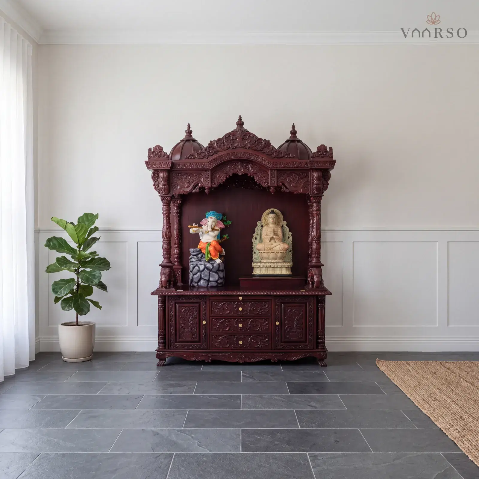 The same mandir in a Hamptons-style living room, shaker panelling below the plaster, honed grey slate underfoot and a fiddle-leaf fig in a ceramic pot to one side