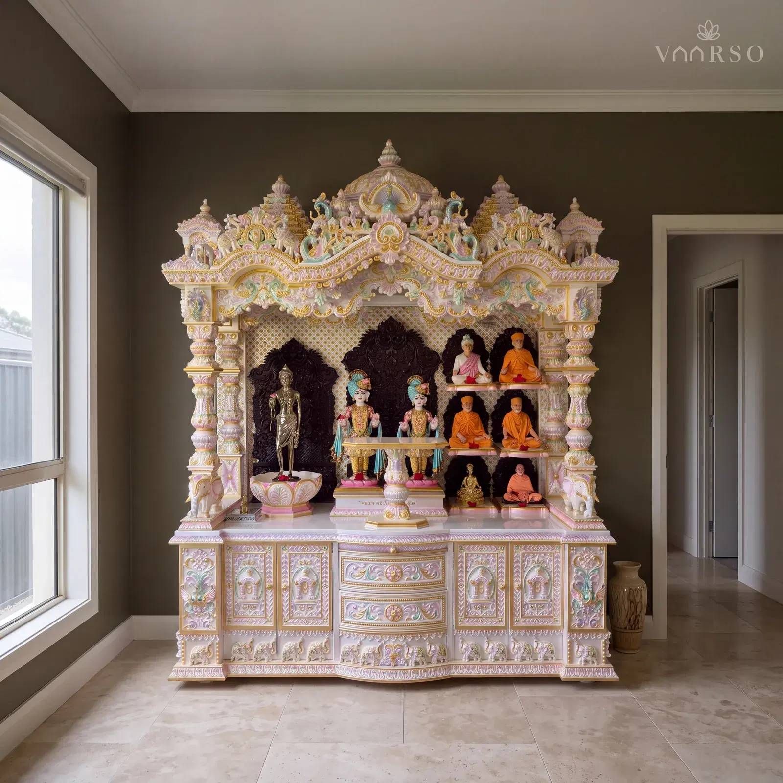The same mandir in a small pooja room, standing in its alcove, honed travertine underfoot and a tall ceramic vessel on the floor to one side