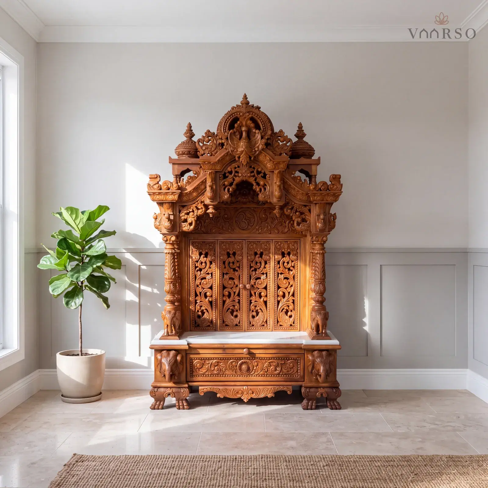 The same mandir in a Hamptons-style living room, shaker panelling below the plaster, honed travertine underfoot and a fiddle-leaf fig in a ceramic pot to one side